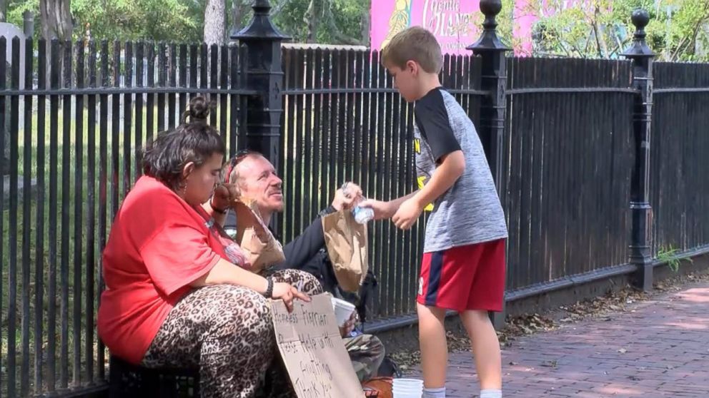 PHOTO: Liam Hannon, 10, hands out homemade lunches to the homeless population of Cambridge, Massachusetts, along with help from his father, Scott Hannon. 