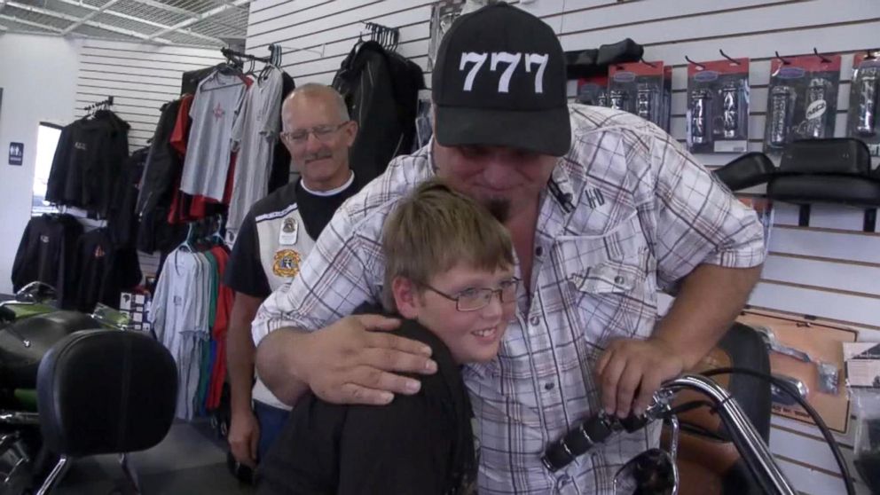 PHOTO: Phil Mick, 11, seen with Brett Warfield, sales manager of KDZ Motorcycle Sales & Service, who organized an escort ride for the boy to his first day of middle school on Aug. 1. 