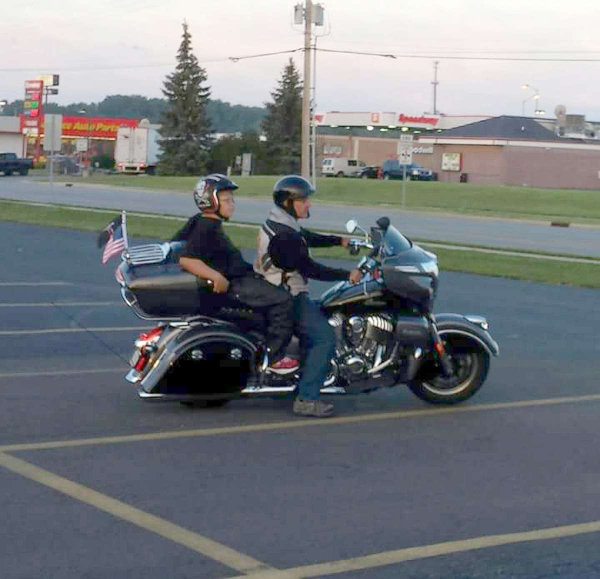 PHOTO: Phil Mick, 11, got a special ride on the back of the motorcycle of Brett Warfield, sales manager of KDZ Motorcycle Sales & Service, on his way to school on Aug. 1 in Indiana.