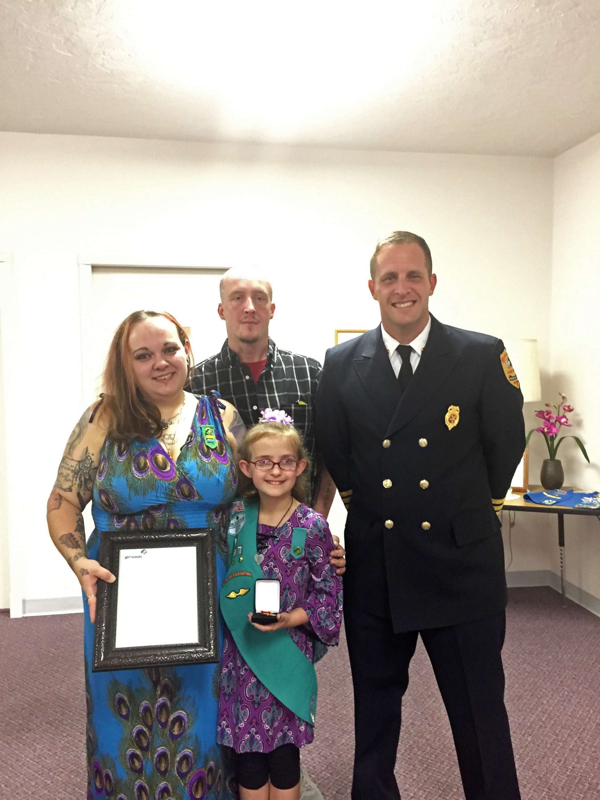 PHOTO: Alexandria, Indiana, Fire Chief Brian Cuneo poses with Melina Lakey, 9, and her parents, Ashley McCollum-Lakey and Jeff Lakey.