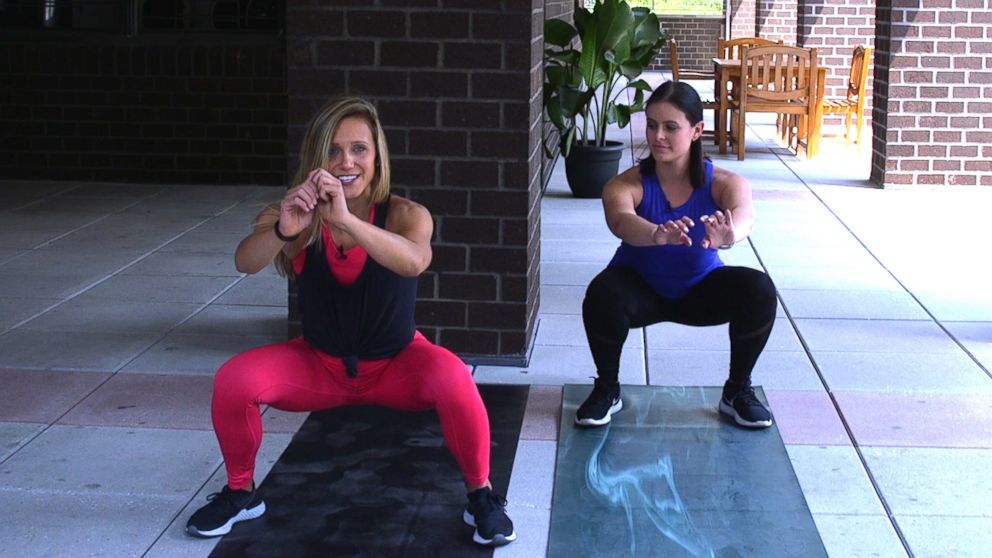 PHOTO: NYC fitness trainer, Jennifer Amoroso shows Dani Kipp how to do a sumo squat jump.