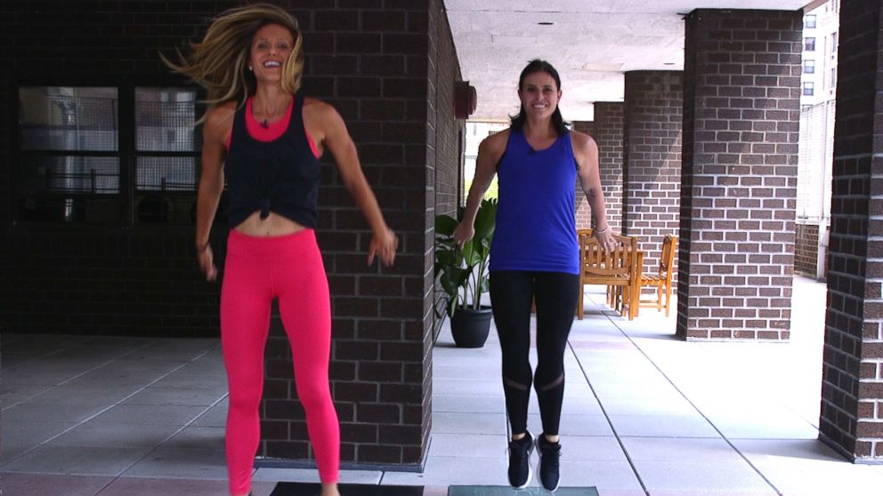 PHOTO: NYC fitness trainer, Jennifer Amoroso shows Dani Kipp how to do a sumo squat jump.