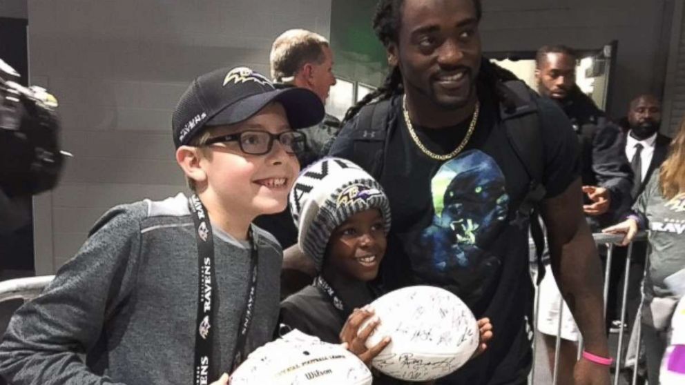 PHOTO: Carl Tubbs, 12, left, and his brother, Miles Tubbs, 10, pose with Baltimore Ravens player Alex Collins on Oct. 22, 2017 in Minnesota.
