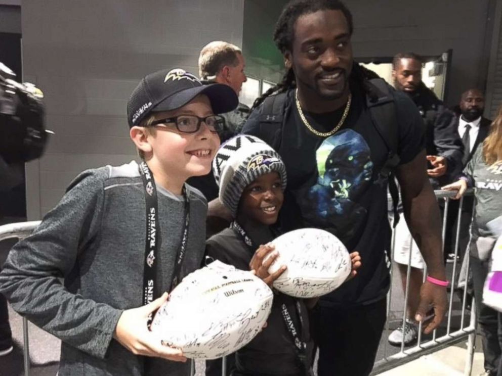 PHOTO: Carl Tubbs, 12, left, and his brother, Miles Tubbs, 10, pose with Baltimore Ravens player Alex Collins on Oct. 22, 2017 in Minnesota.