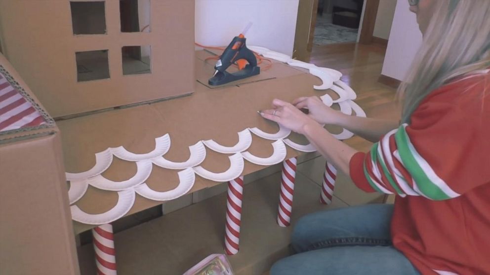 PHOTO: Jessica Josephs glues white paper plates to the roof to resemble snow.