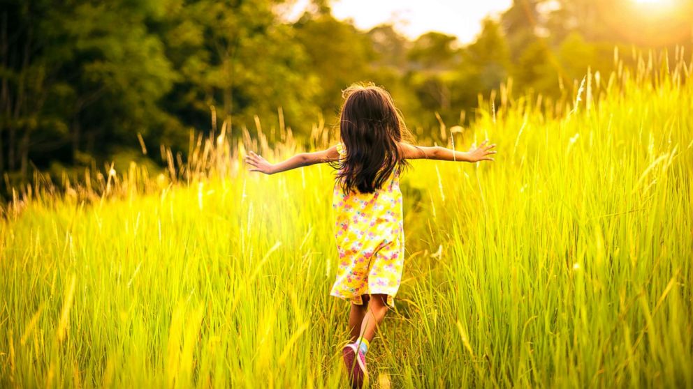 Little girl running in a meadow.