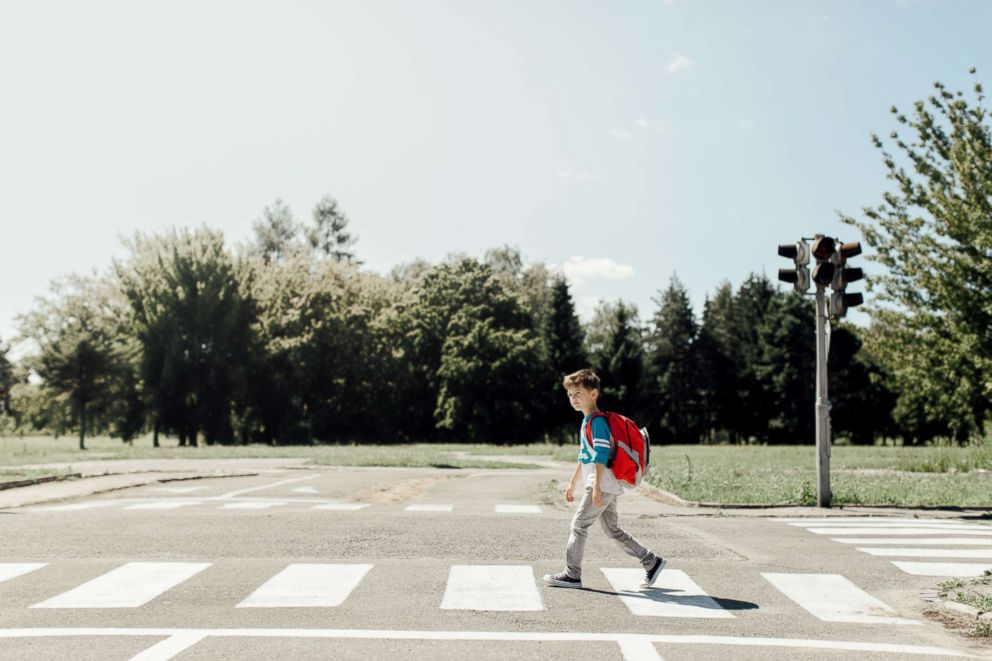 PHOTO: A young boy crosses the street.