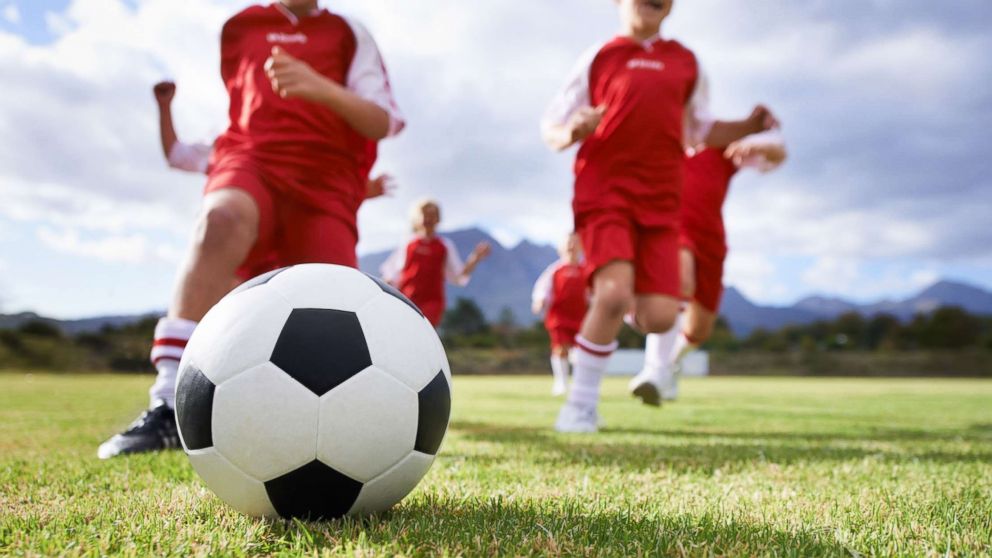 Children kick a soccer ball in an undated stock photo.