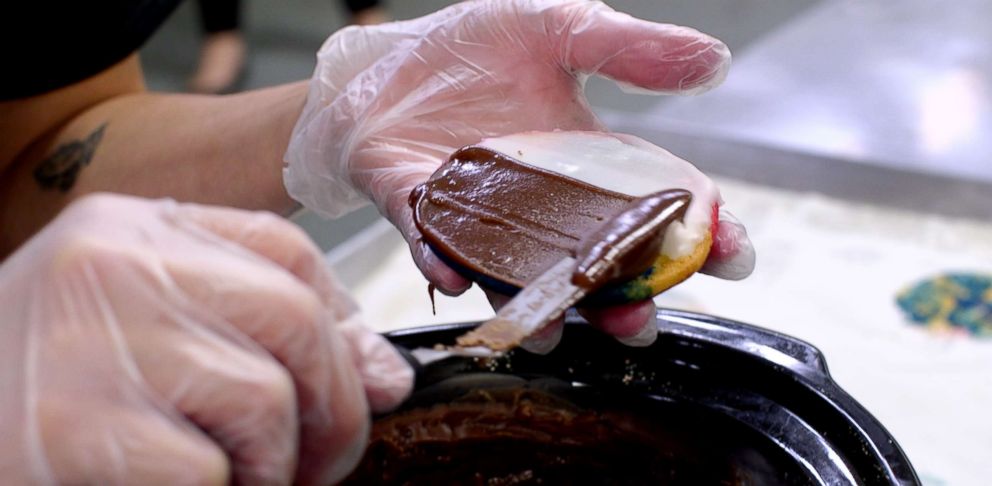 PHOTO: Once the cookies are baked they are turned over and iced, white side always first.