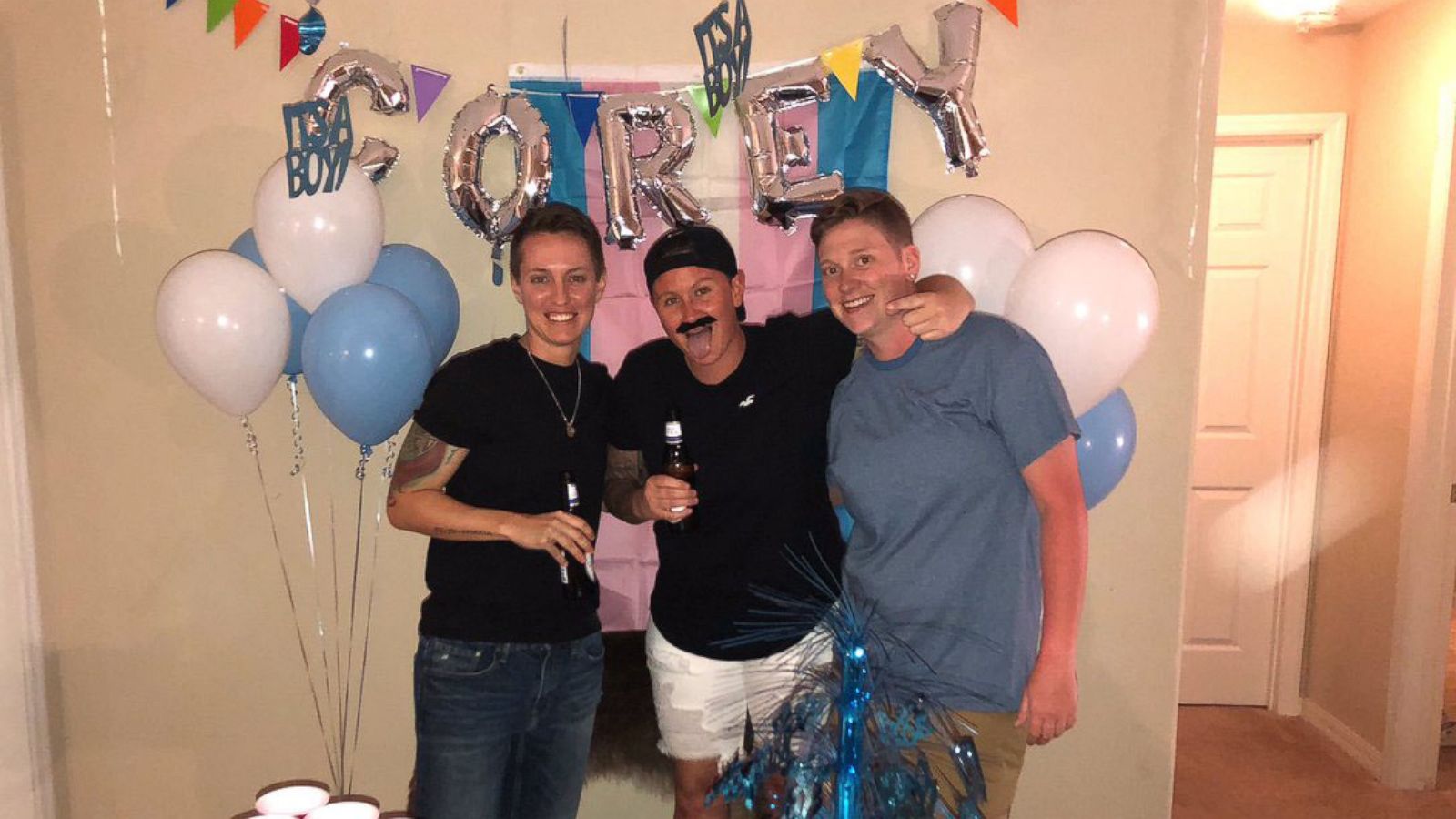 PHOTO: Corey Walker, center, seen with friend Erin Knoll, right, and his roommate Christina Craft at a party to celebrate Corey's transitioning to a male on May 24, 2018.