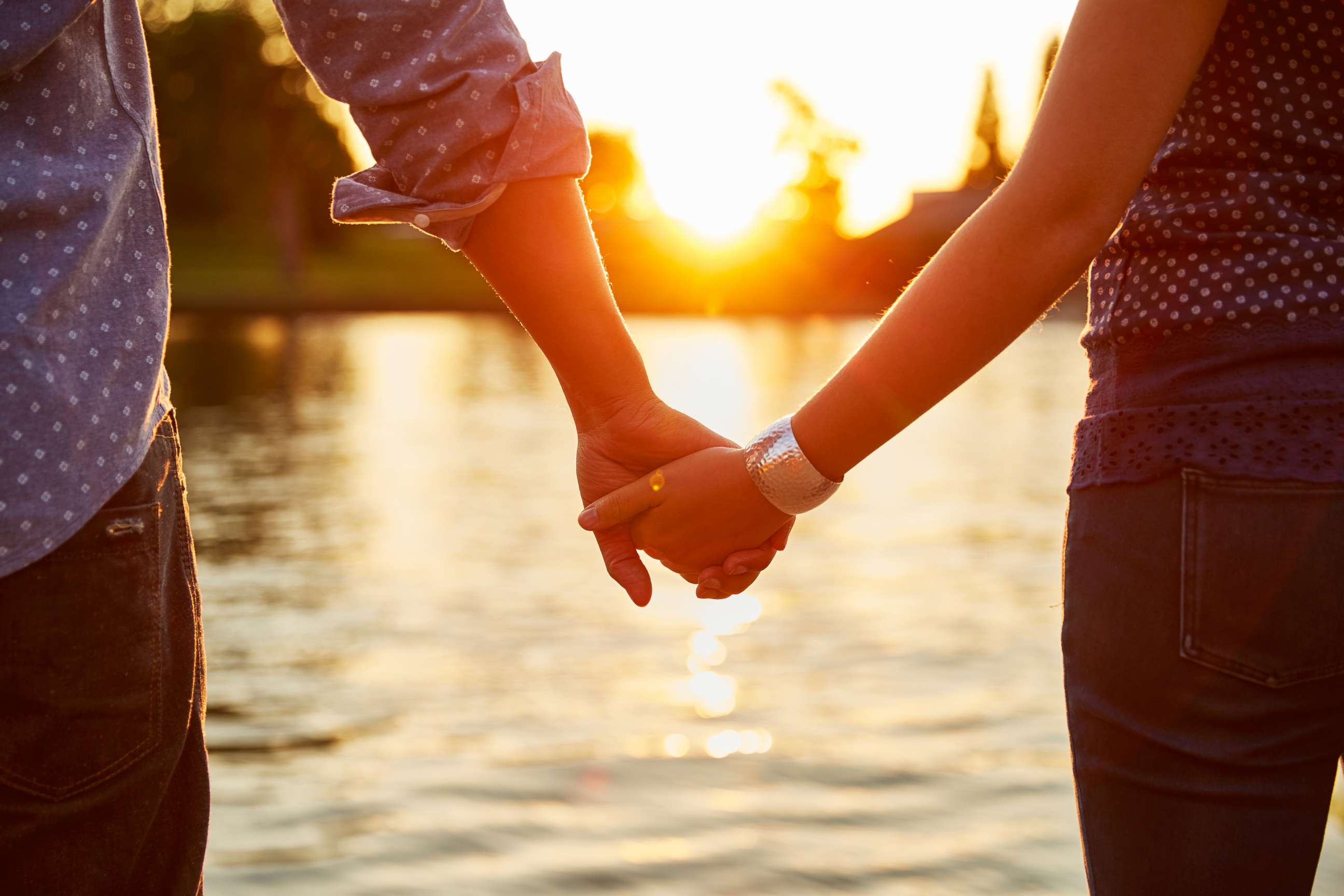 PHOTO: A couple holds hands by the river in this undated stock photo.