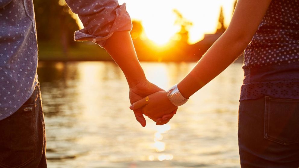 PHOTO: A couple holds hands by the river in this undated stock photo.