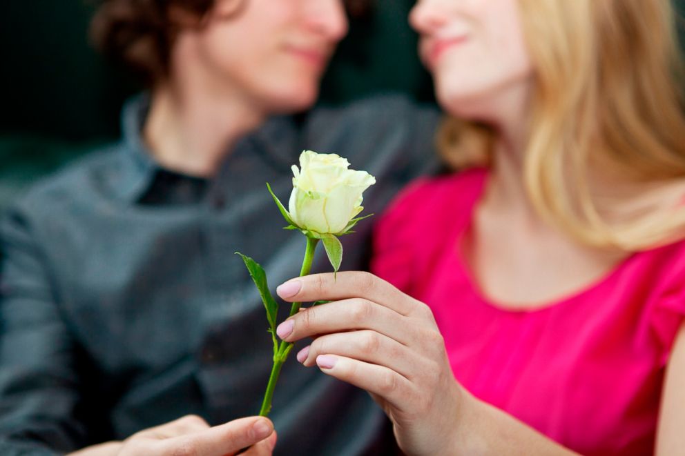 PHOTO: A couple shares a flower in this undated stock photo.