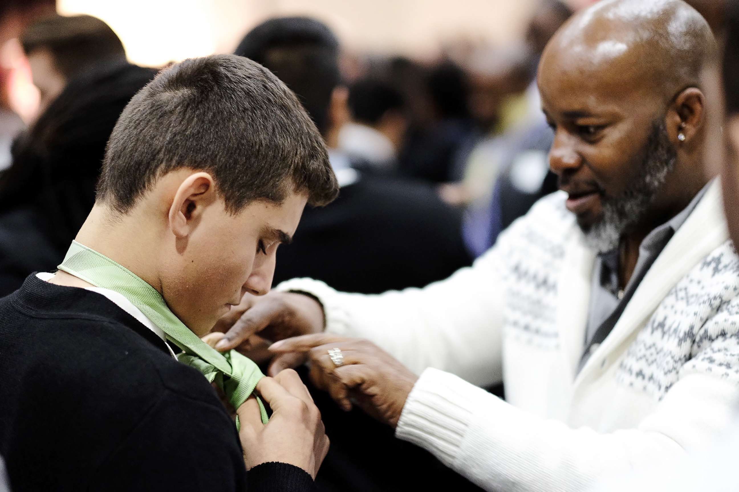 PHOTO: A mentor teaches a student to tie a tie at Billy Earl Dade Middle School's "Breakfast with Dads" event on Dec. 14, 2017.