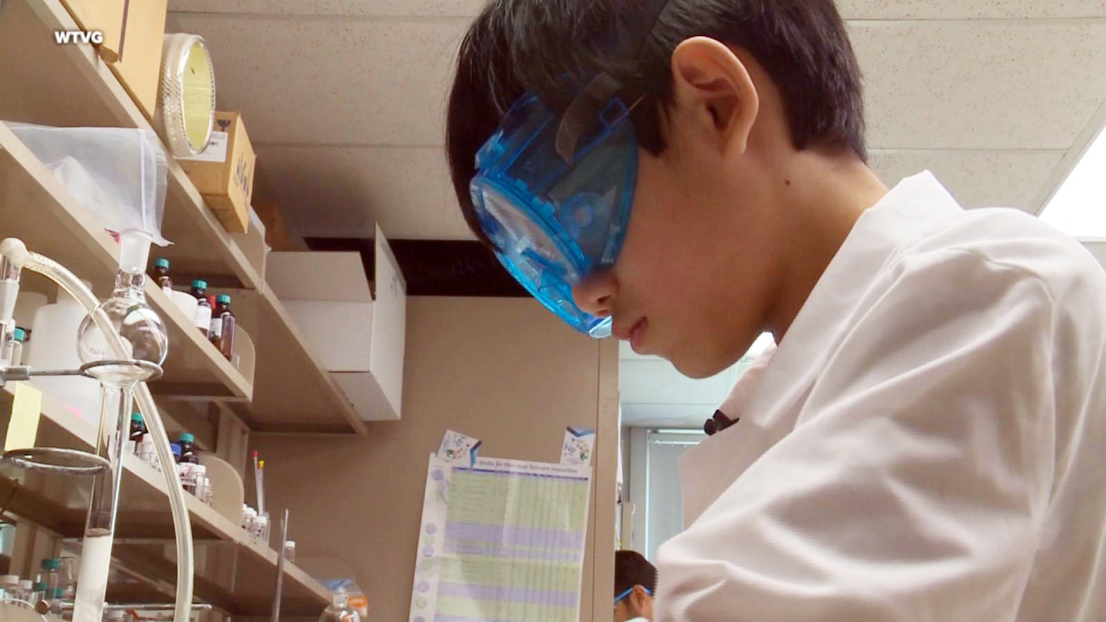 PHOTO: Daniel Liu looks into a microscope at the University of Toledo laboratory.