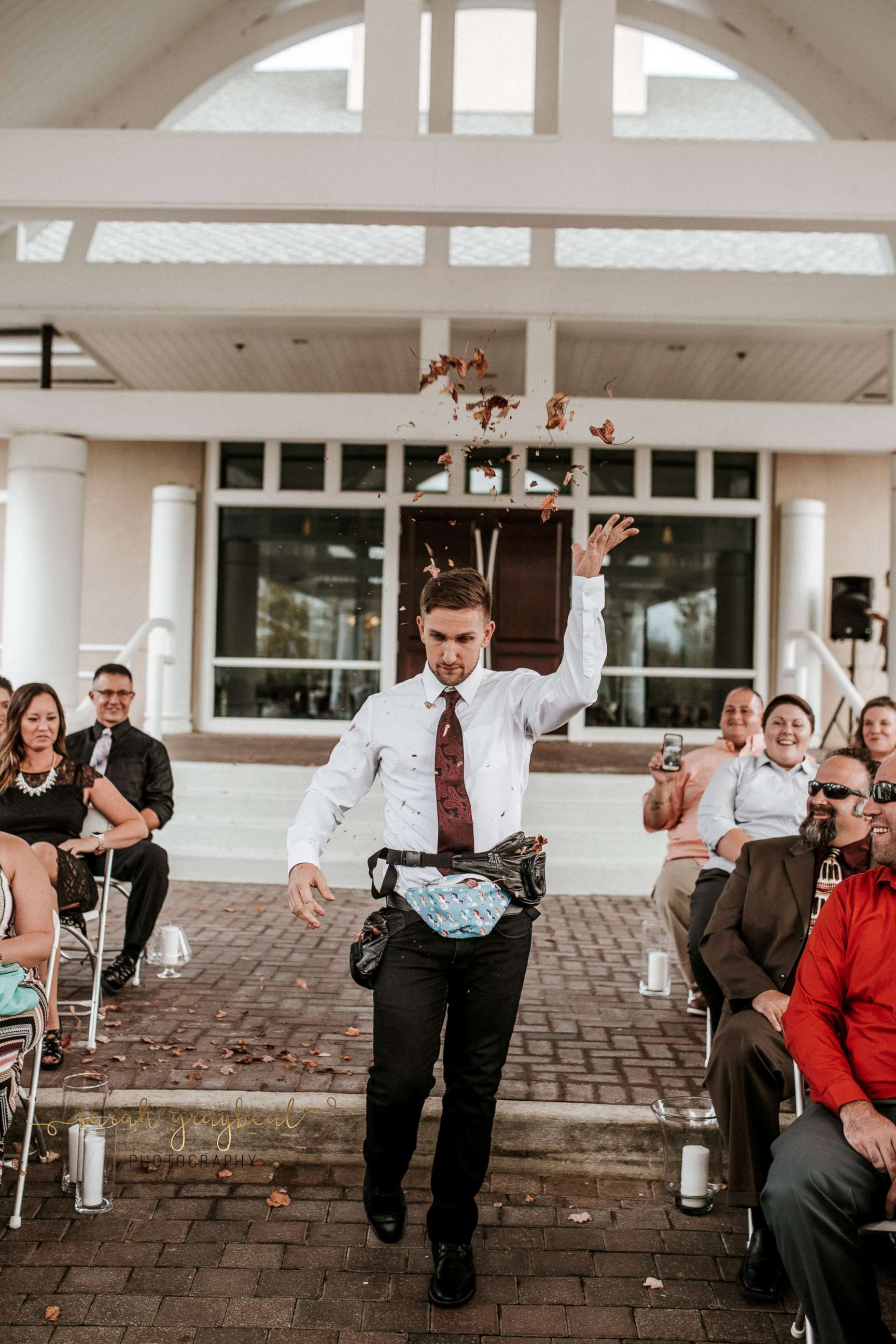 PHOTO: Jake Clark of Dayton, Ohio, served as his friends' flower man, throwing fall foliage out of fanny packs on Oct. 7.