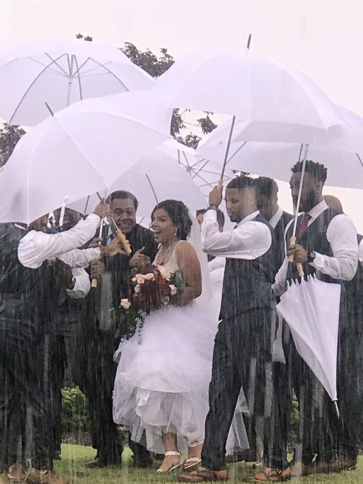 PHOTO: Bride Diana Joseph was protected from rain on her wedding day, May 20, 2018, thanks to her groomsmen.