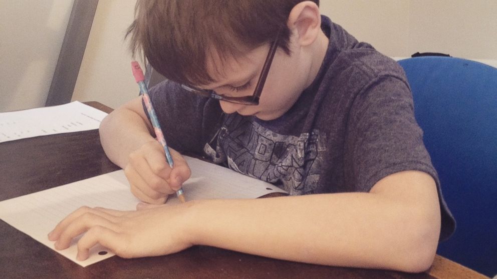 PHOTO: Beckett Dillon studies in his family's home in this 2015 photo.