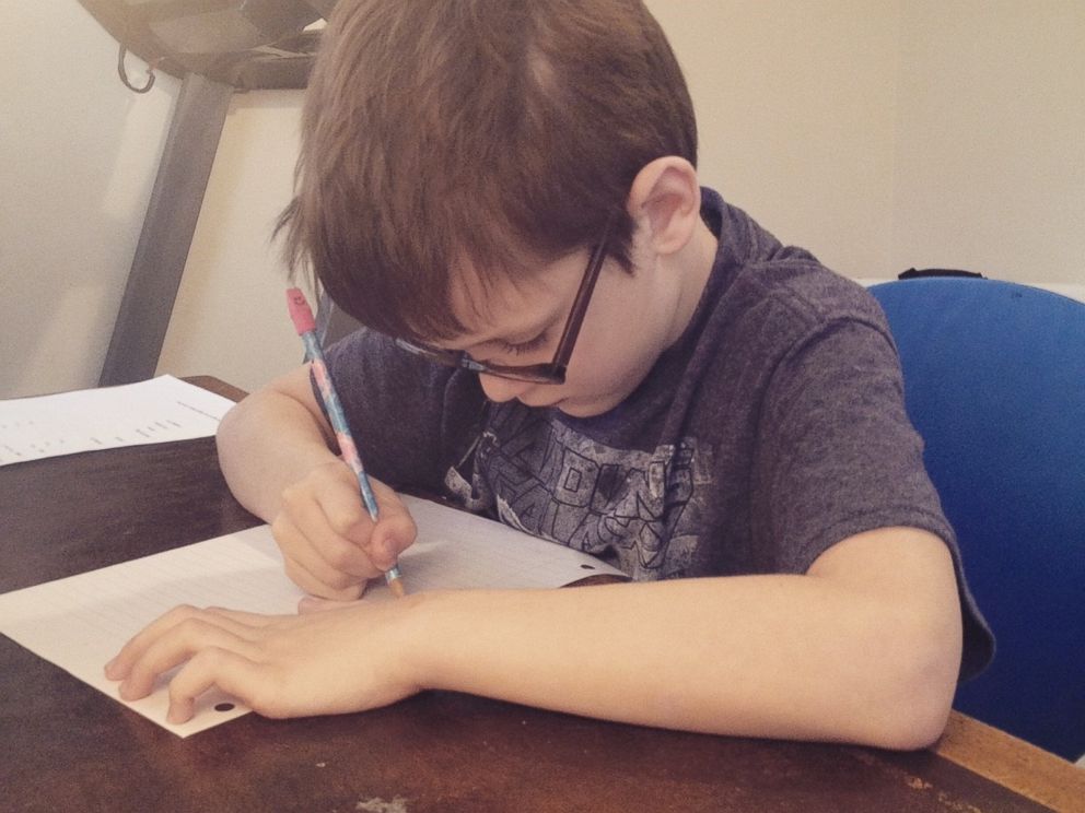 PHOTO: Beckett Dillon studies in his familys home in this 2015 photo.