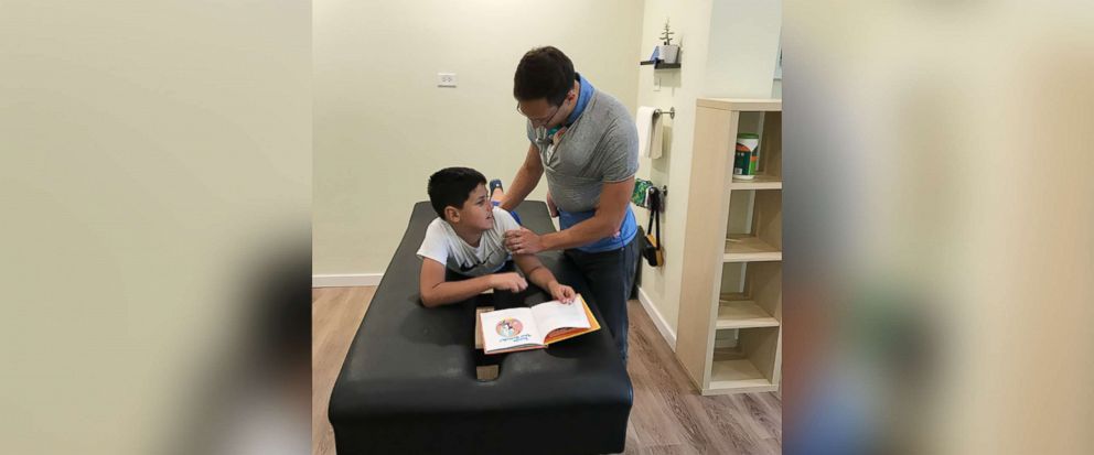 PHOTO: Yanni Rackos, 9, a patient of Roots Family Chiropractic in Chicago, Illinois, is examined by Dr. Tom Williams on July 12.
