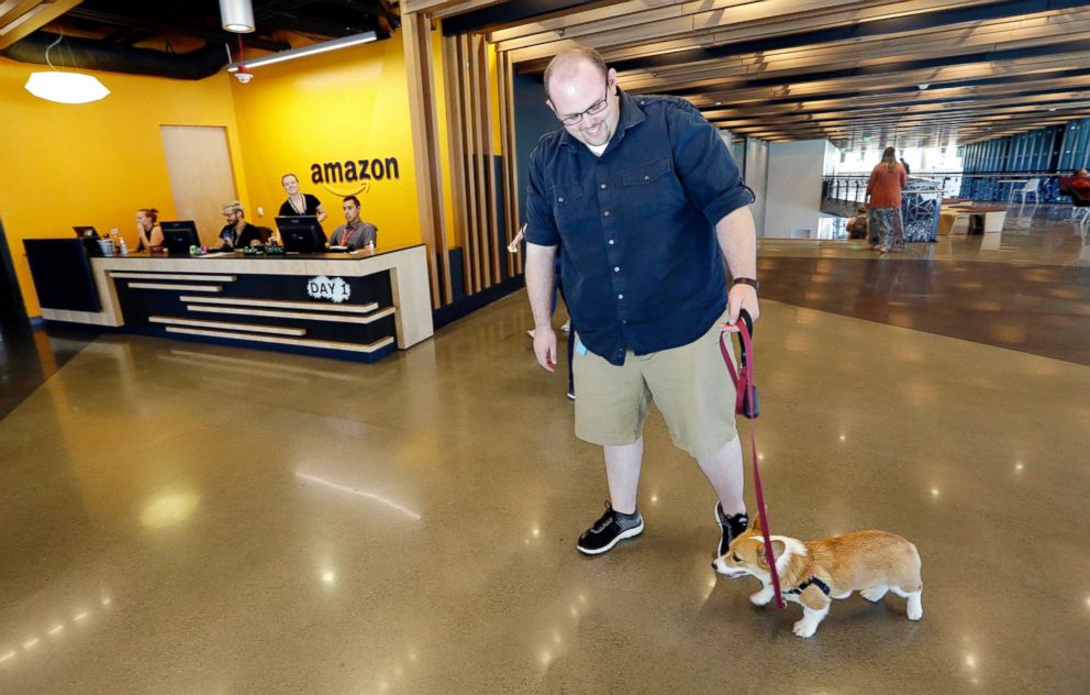 PHOTO: An employee arrives with his dog inside Amazon's Day One building in downtown Seattle, Sept. 27, 2017.