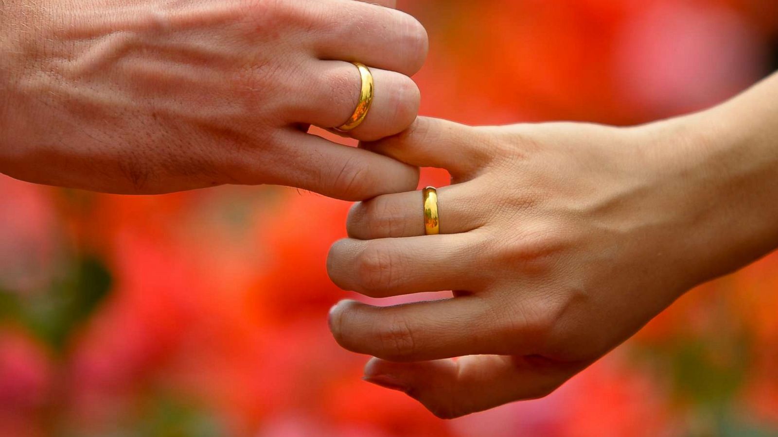 PHOTO: A man and woman hold hands while showing off their beautiful gold engagement rings in this undated stock photo.