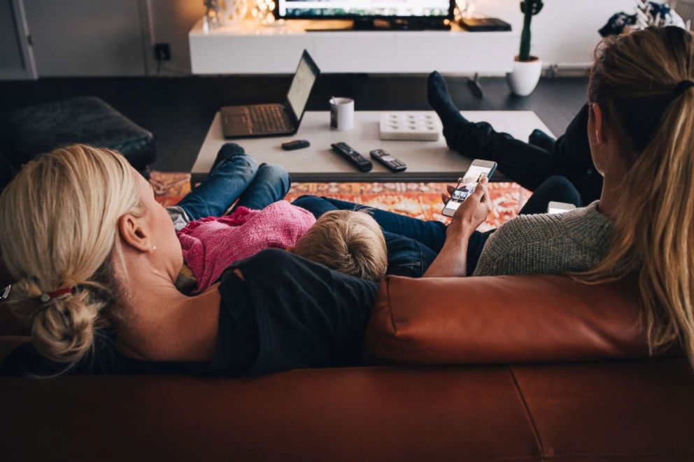 PHOTO: Family using a smart phone at home.