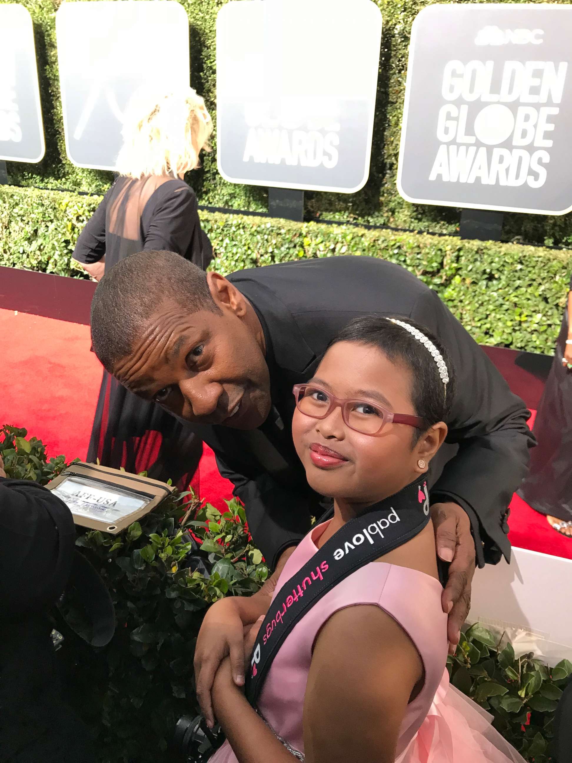 PHOTO: Francine Gascon, 10, poses with Denzel Washington as she takes photos of stars on the Golden Globes red carpet.
