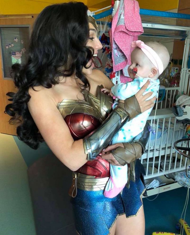 PHOTO: Actress Gal Gadot holds 7-month-old Karalyne Sahady, a patient at Inova Children's Hospital in Falls Church, Va., July 6, 2018. 