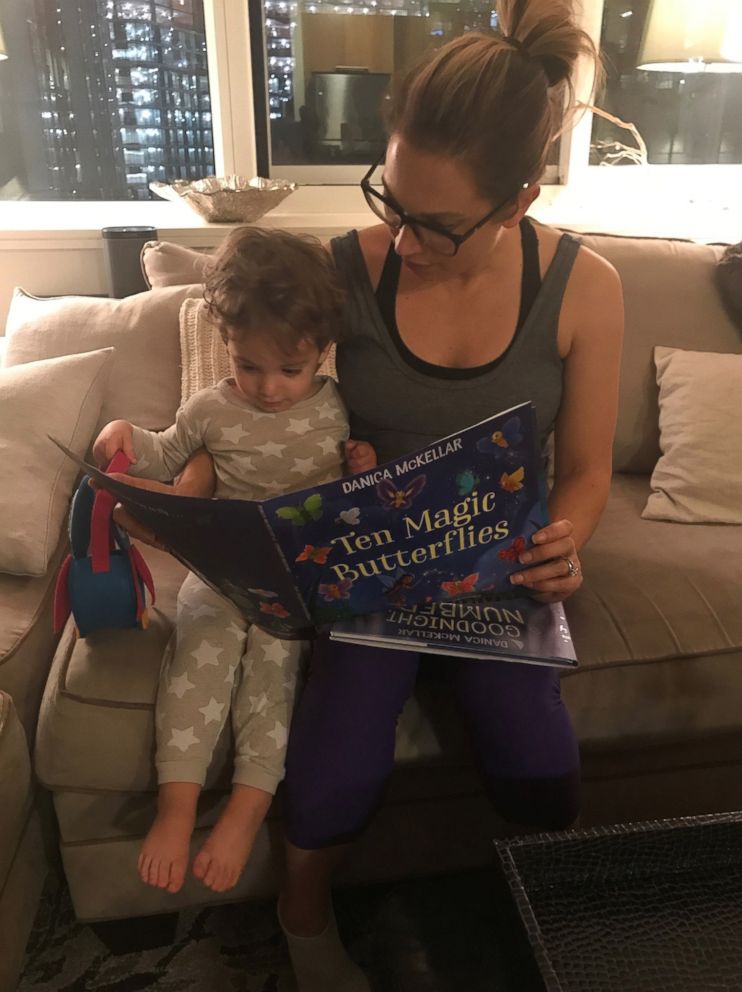 PHOTO: ABC News chief meteorologist Ginger Zee reads to her son, Adrian.