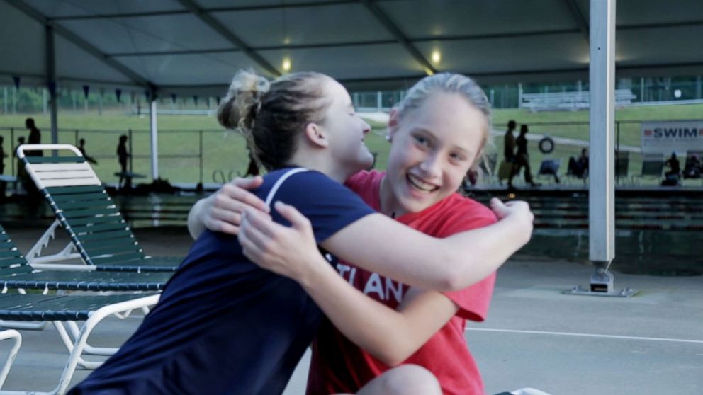 PHOTO: Grace Bunke, 14, and McClain Hermes, 16, hug after talking about their experience with bone cancer and blindness, respectively.