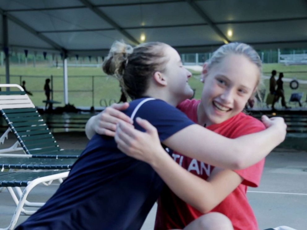 PHOTO: Grace Bunke, 14, and McClain Hermes, 16, hug after talking about their experience with bone cancer and blindness, respectively.