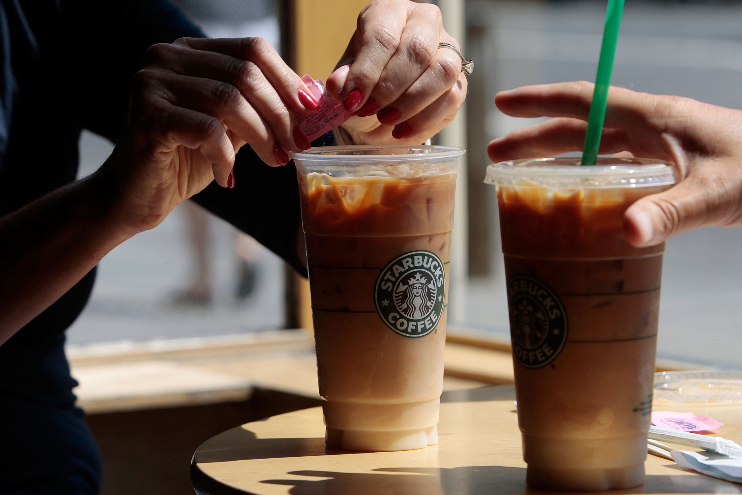 PHOTO: A couple has iced coffee drinks at a Starbucks Coffee shop in lower Manhattan, New York.