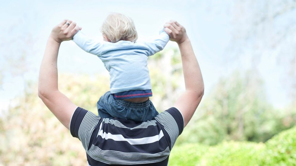 A father holds his son in an undated stock photo.