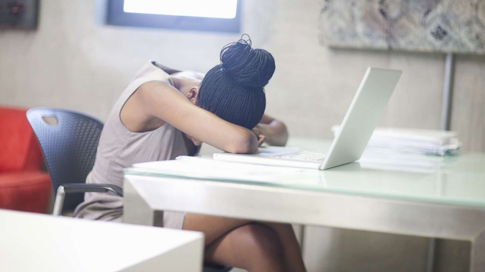 PHOTO: A woman puts her head down at work in an undated stock photo.