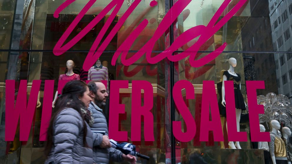 January is actually the best month to get deals on outerwear, exercise equipment and other items that are deeply discounted. Pictured: Pedestrians walk past a store advertising a winter sale in New York City, Jan. 6, 2014.