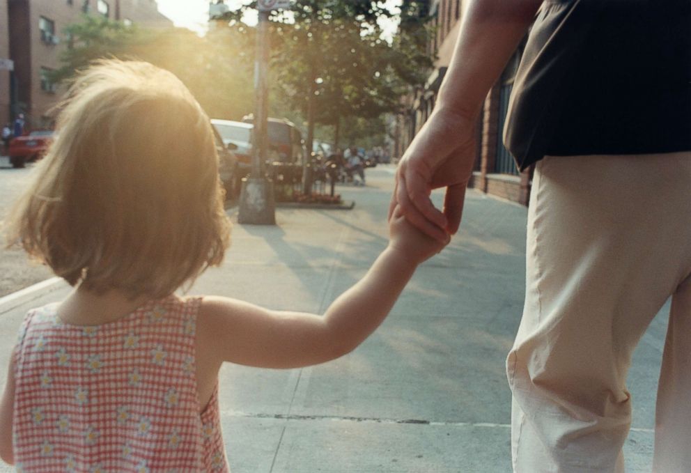 PHOTO: A parent holds their child's hand.