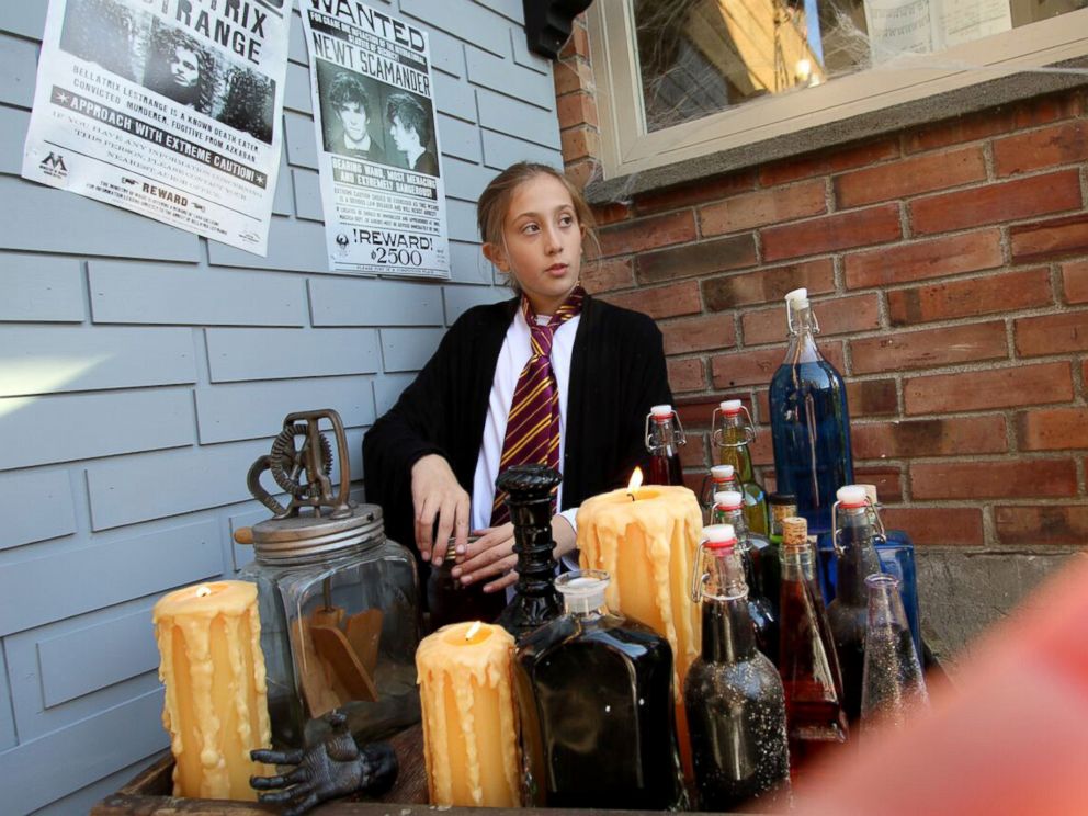 PHOTO: Visitors strolled past storefronts for Quidditch supplies and potions.