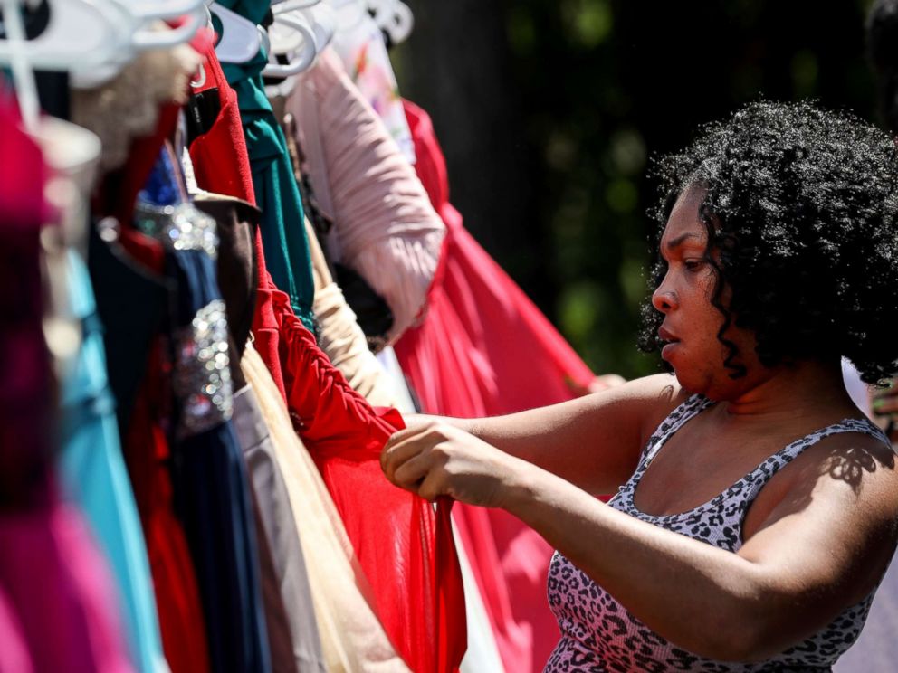 PHOTO: Shyra Moody looks for a homecoming dress for the daughter of a friend who lost everything in Hurricane Harvey, at the home of Tammy Reel, Sept. 24, 2017, in Spring, Texas.