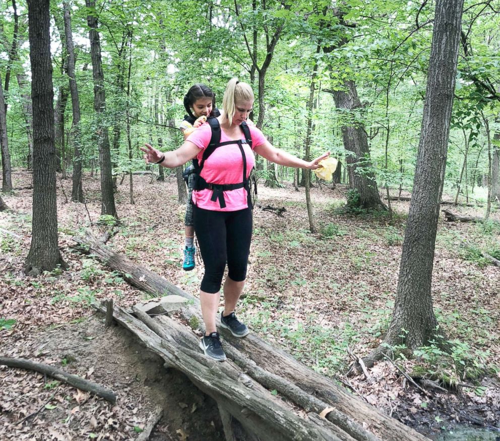 PHOTO: Helma Wardenaar carried her student, who has cerebral palsy, on a class hike.