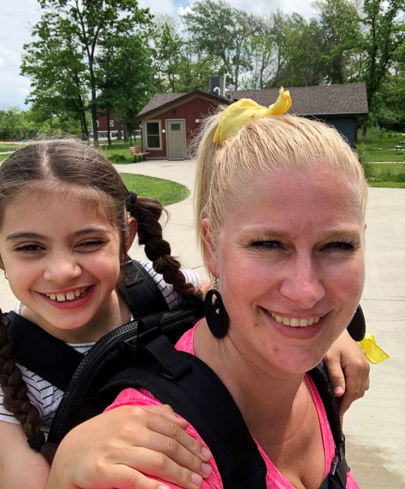 PHOTO: Helma Wardenaar carried her student, who has cerebral palsy, on a class hike.