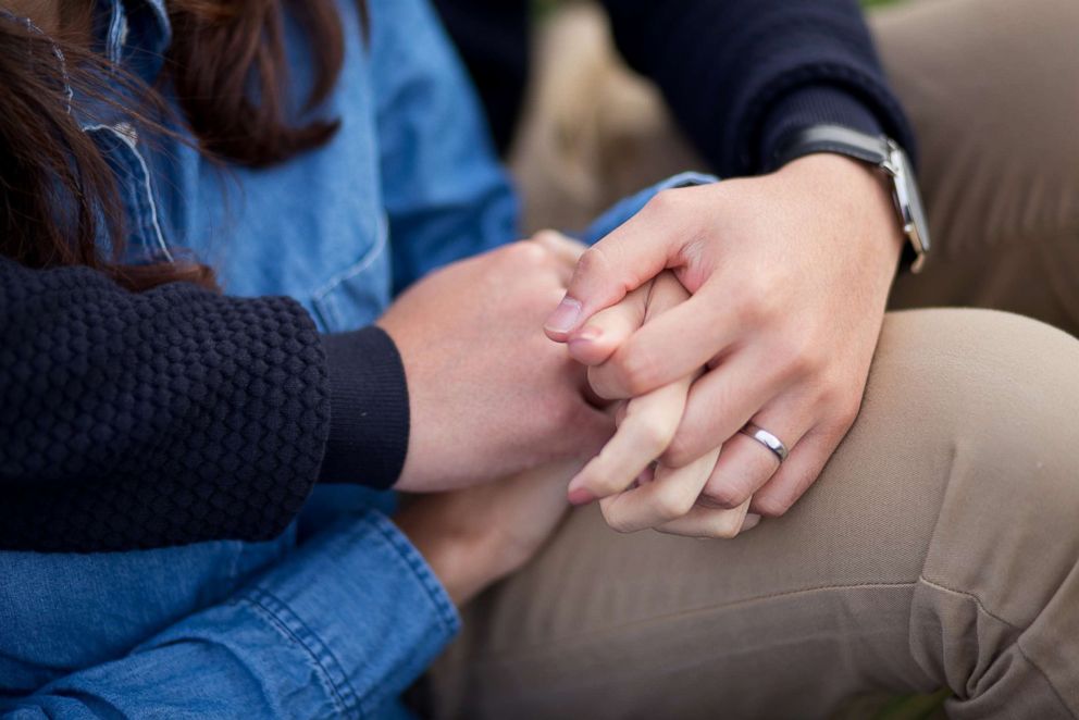 PHOTO: Stock photo of a couple holding hands.