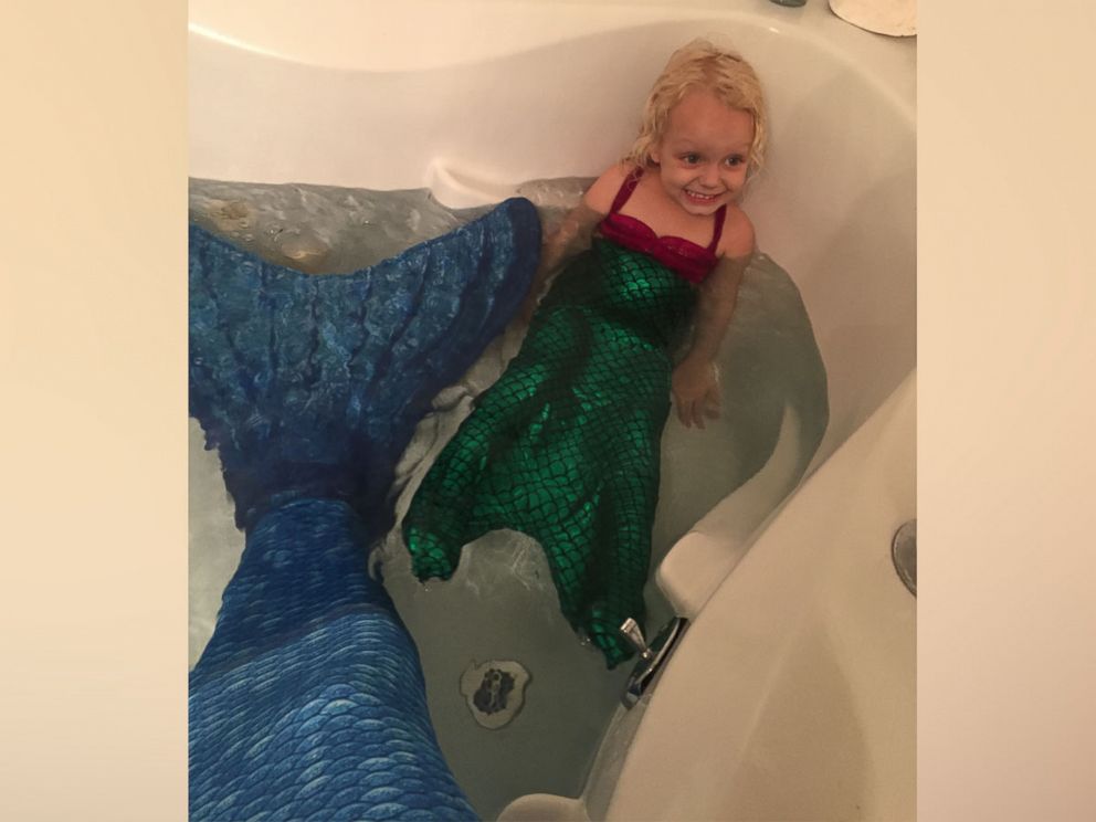 PHOTO: Keegan Carnahan, of Tampa, Florida, and 3-year-old Alidy Clark had a blast playing with their mermaid tails in the bath tub. 