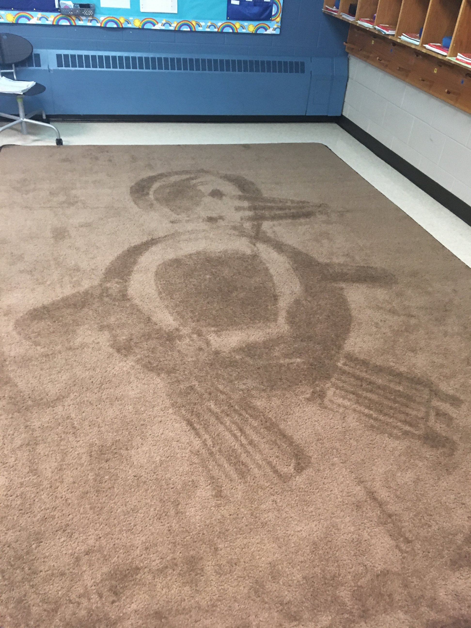 PHOTO: School janitor Ron Munsey vacuums artistic designs into classroom rugs as daily surprise for kids.