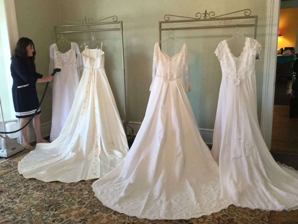 PHOTO: Bridal store owner Allison Drake, of Madison, N.C., stands next to wedding gowns donated to her store by Margarette Powell.