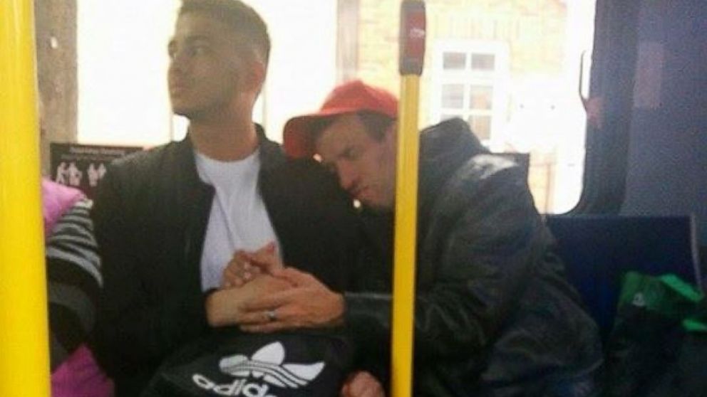 Godfrey Coutto, 21, holds the hand of a man with special needs to comfort him on a crowded bus.
