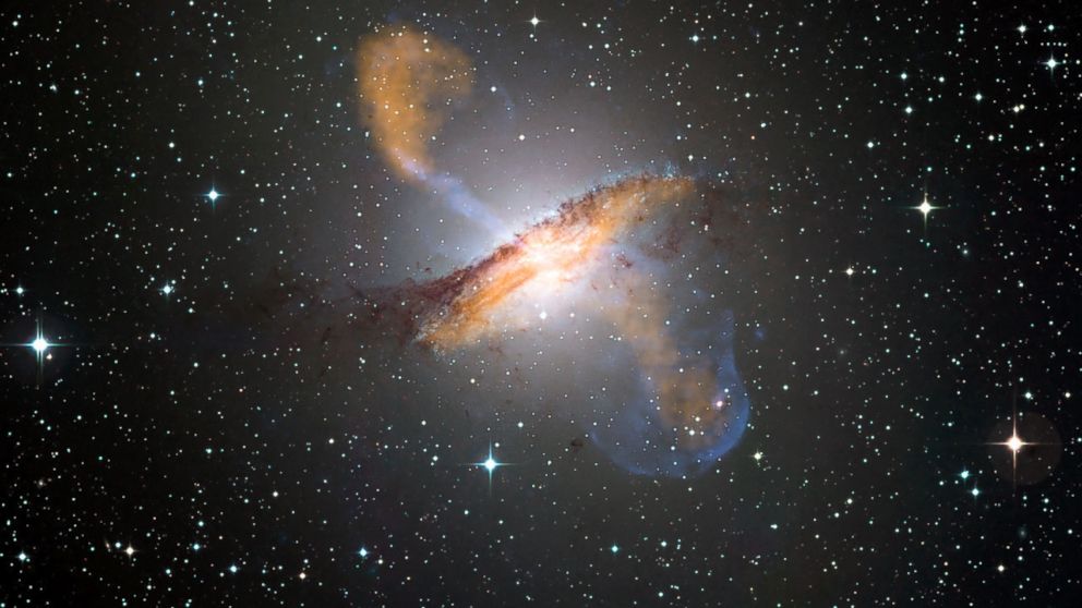 PHOTO: An image created using x-ray, microwave, and visible imagery reveals the jets and radio-emitting lobes emanating from Centaurus A's central black hole. 