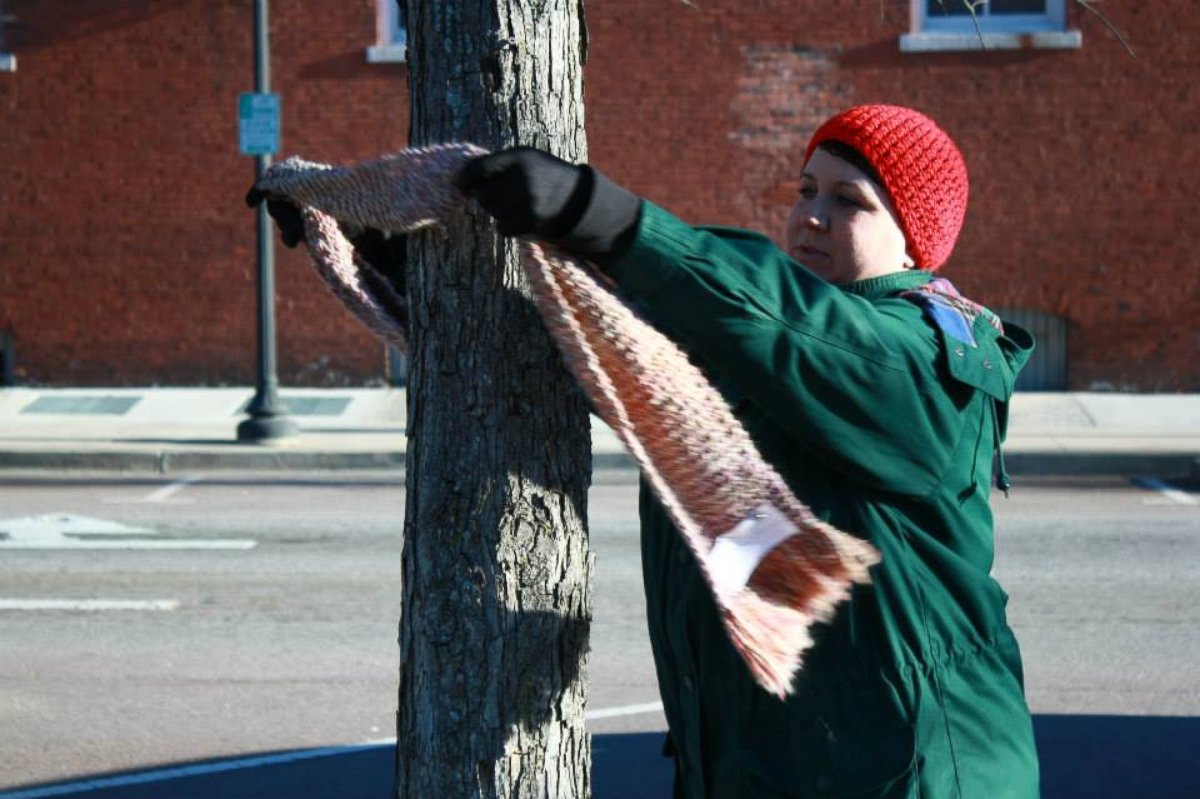 PHOTO: Carrie Sexton ties a scarf to a tree during her Chase the Chill of Central GA's first event. 