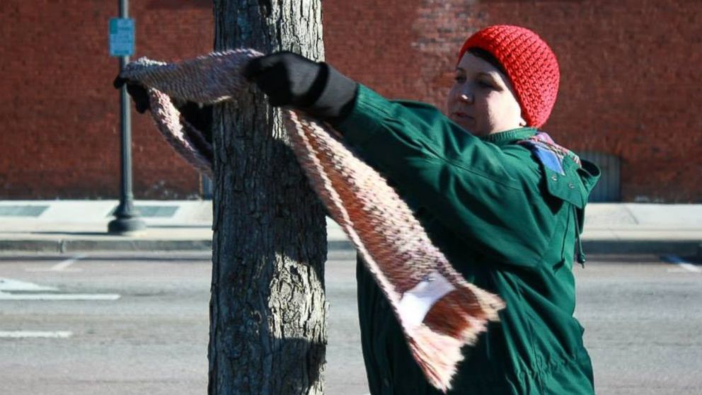 PHOTO: Carrie Sexton ties a scarf to a tree during her Chase the Chill of Central GA's first event. 