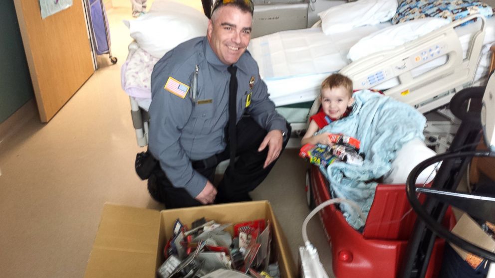 PHOTO: Ethan receives a car collection from a Utah security officer. 